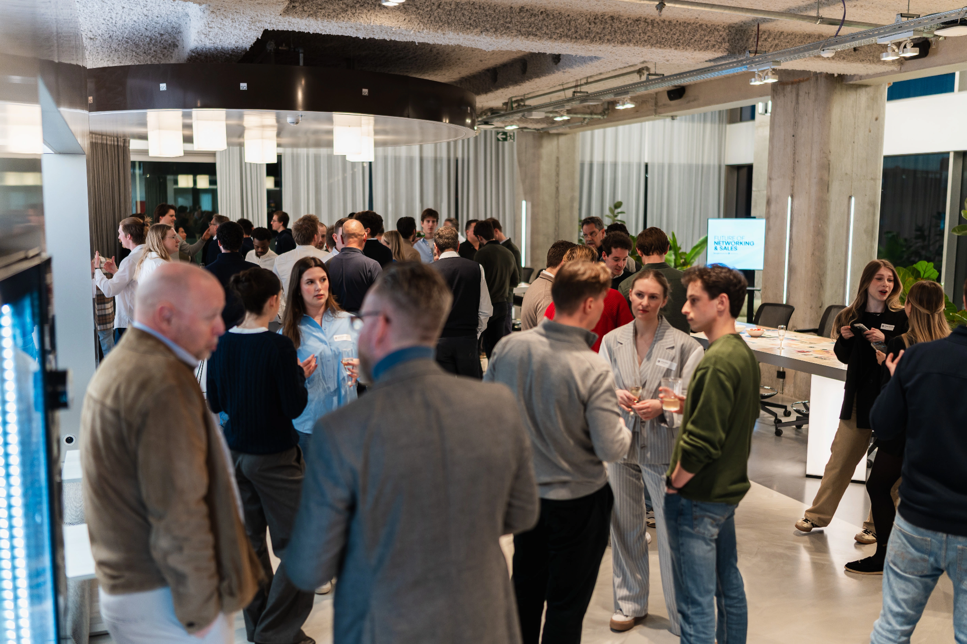 Networking conversation at a B2B event with the new contact ready to sync into Odoo CRM